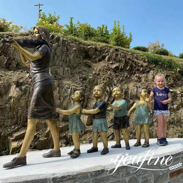 bronze children and teacher statue