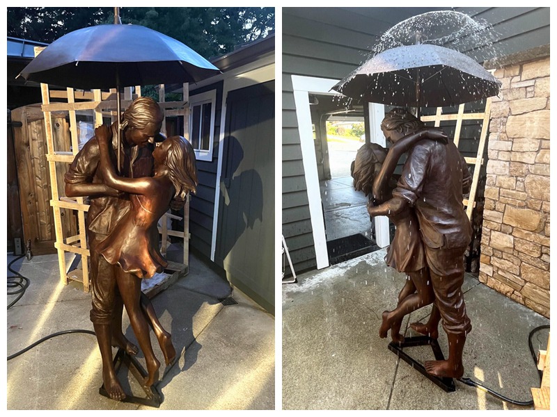 bronze umbrella-holding man sculpture fountain